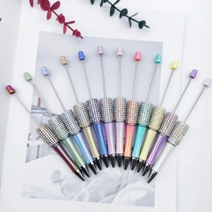 Detailed close-up of DIY beadable pens with rhinestones in colorful gradient finishes