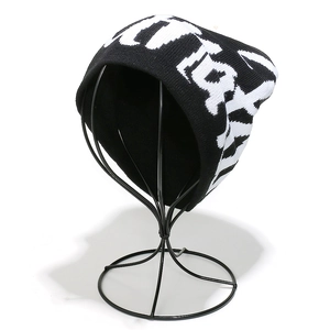 Detailed close-up of black and white jacquard knit beanie with street style patterns