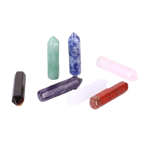 Set of seven natural crystal hexagonal pillars in various colors for yoga and energy healing