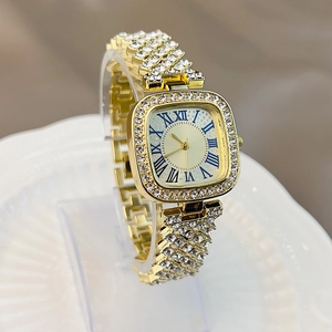 Close-up of gold square watch with Roman numerals and diamond-encrusted bracelet link