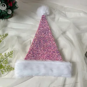 Close-up of pink sequined Christmas hat with white plush trim and fuzzy pom-pom detail