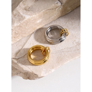 Minimalist 18k gold and silver stainless steel rings on natural stone background