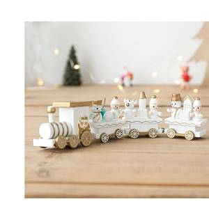 Macro view of white and gold wooden Christmas train with snowman and bear figurines