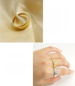 Detail of 18K gold plated stainless steel rings with ribbed texture and adjustable opening