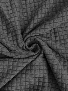 Close-up of charcoal grey waffle knit fabric texture on a casual men's zip-up sweatshirt