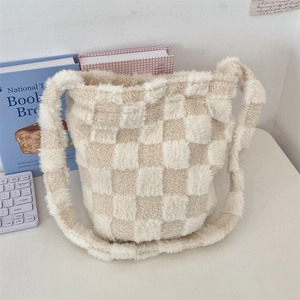 Detail shot of the plush checkered tote bag featuring soft beige and brown faux fur texture