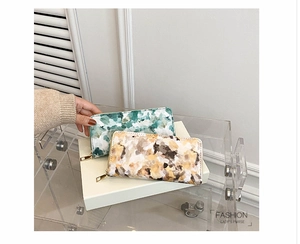 Detail of floral pattern women wallets with zipper closure on professional display stand