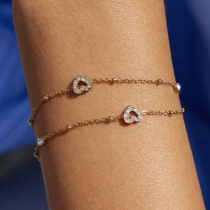 Gold double-layered bead chain bracelet featuring sparkling heart pendants for women