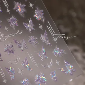 Macro view of holographic purple butterfly and floral nail art stickers with laser effect