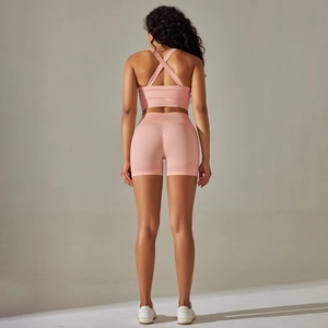 Détail de l'ensemble de yoga rose avec brassière croisée et short taille haute galbant