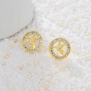 Close-up of gold-plated hummingbird stud earrings with sparkling cubic zirconia pavé