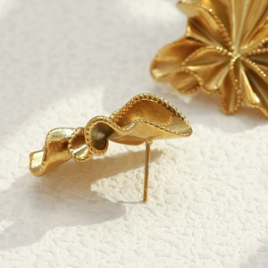 Macro detail of 18K gold plated wrinkled flower stud earrings with matte texture