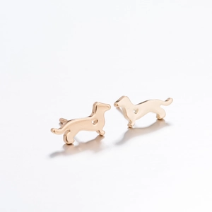 Polished gold dog-shaped stud earrings with heart cut-out in minimalist style