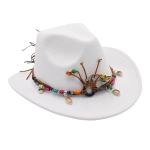 Detail of white felt cowboy hat featuring brown braided leather band and colorful ethnic beads