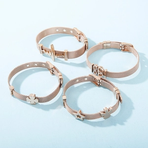 Detailed view of rose gold mesh bracelets with heart and clover charms for Mother's Day