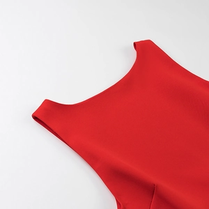 Macro detail of red ruffle halter dress neckline showing refined fabric texture