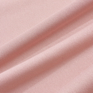 Close-up of pink polo shirt fabric showing breathable moisture-wicking knit texture