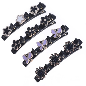 Detailed macro view of acetate hair pins with golden flower and butterfly motifs