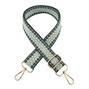 Detail of 3.8cm woven geometric guitar strap for bags with golden metal lobster clasps