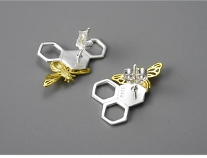 Macro detail of S925 sterling silver stamp on handmade bee and honeycomb stud earrings