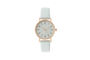Detail of rose gold watch with light blue leather strap and textured white dial