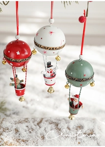 Detailed view of Christmas iron hot air balloon ornaments with elk and snowman designs