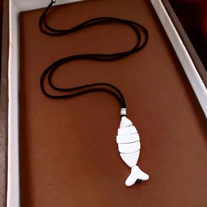 Articulated white fish bone pendant on a black woven long cord necklace