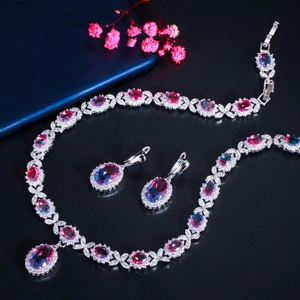 Detailed view of necklace and earrings set with pink to purple gradient zircon stones