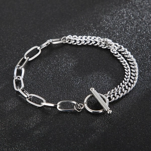 Detail of silver OT toggle clasp and mixed link chain on gray matte background