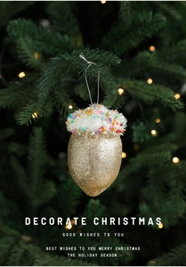 Christmas ice cream ornament with gold glitter base and white snow top on tree