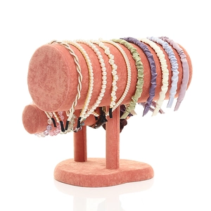 Pink velvet headband holder and bracelet display stand with multiple hair accessories
