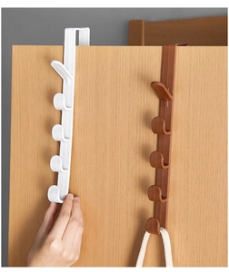 Over-the-door 5-hole plastic hanger rack in white and brown on a wooden door
