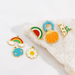 Colorful enamel DIY charms in 14K gold stainless steel including rainbow and daisy designs