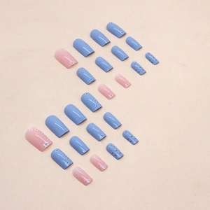 Blue and pink press-on nails set with delicate white floral patterns and dotted designs