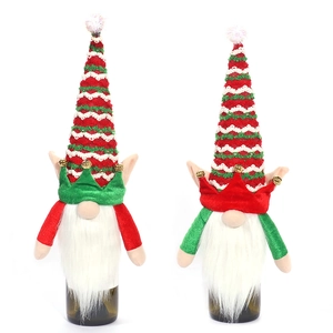 Christmas gnome wine bottle covers set with knitted hats and bells on white background