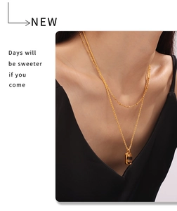 Gros plan sur un collier double rang en titane plaqué or 18 carats avec pendentif œil de tigre