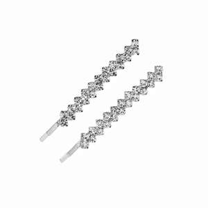 Macro view of silver alloy hair clips with sparkling clear rhinestones on white base