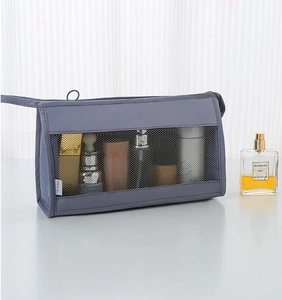 Detail of grey travel toiletry bag with black mesh window and a white 'TRAVEL' label