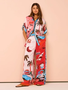 Detail of tropical print two-piece resort set with wide-leg pants and short sleeve shirt