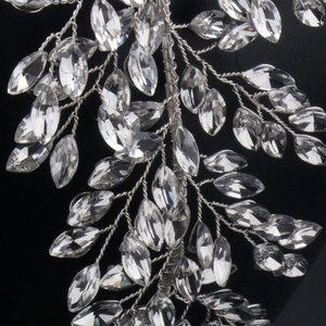 Detailed view of silver bridal hairpiece with crystal leaves and twisted wire accents