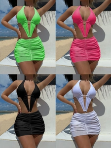 Detail showing the ruched mini skirt and metal ring buckle on the cutout swimsuit set
