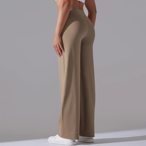 Close-up of high-waist wide-leg yoga pants showing premium fabric texture and draped hem