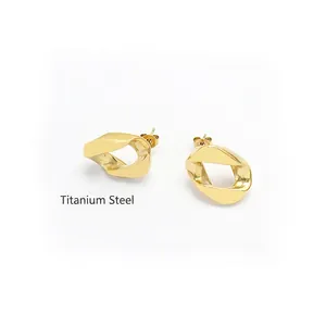 Boucles d'oreilles géométriques irrégulières en or et acier titane 18 carats