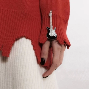 Close-up of a Y2K style guitar hair clip with black and white enamel and silver alloy edges
