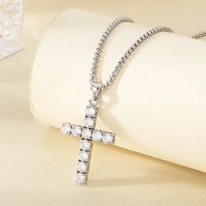 Detail of silver cross pendant with micro-pave zircons and textured box chain