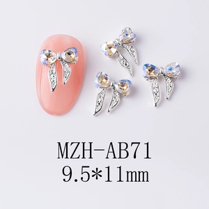 Vue macro de bijoux d'ongles en nœud argenté avec strass AB, taille 9,5x11mm