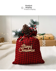 Detail of red and black buffalo plaid Christmas gift bag with pine needles and pine cones