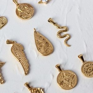 Collection of 18K gold plated titanium steel pendants featuring snake and coin designs