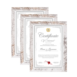 Macro shot of three stacked vintage wooden certificate frames with white grain texture