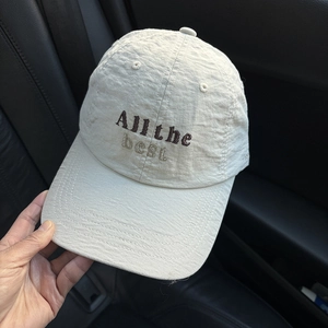 Close-up of All the best embroidery on beige cotton baseball cap with textured fabric